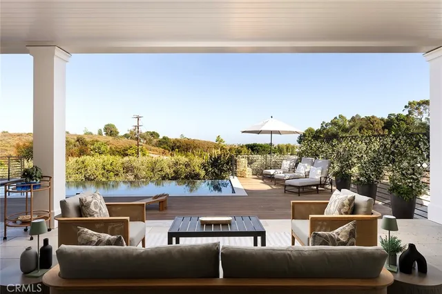 a view of a terrace with couches and sky view