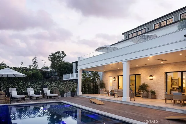 a patio with a table and chairs under an umbrella