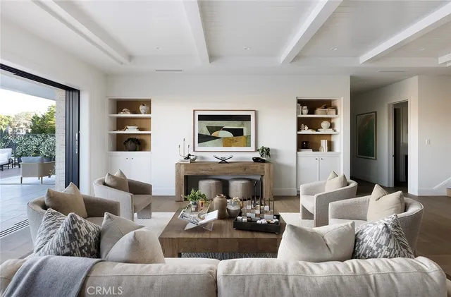 a living room with furniture fireplace and a large window