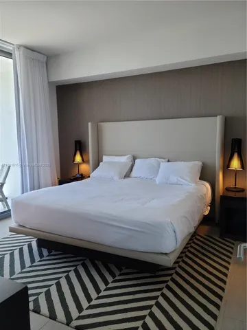 a bed sitting in a bedroom next to a window