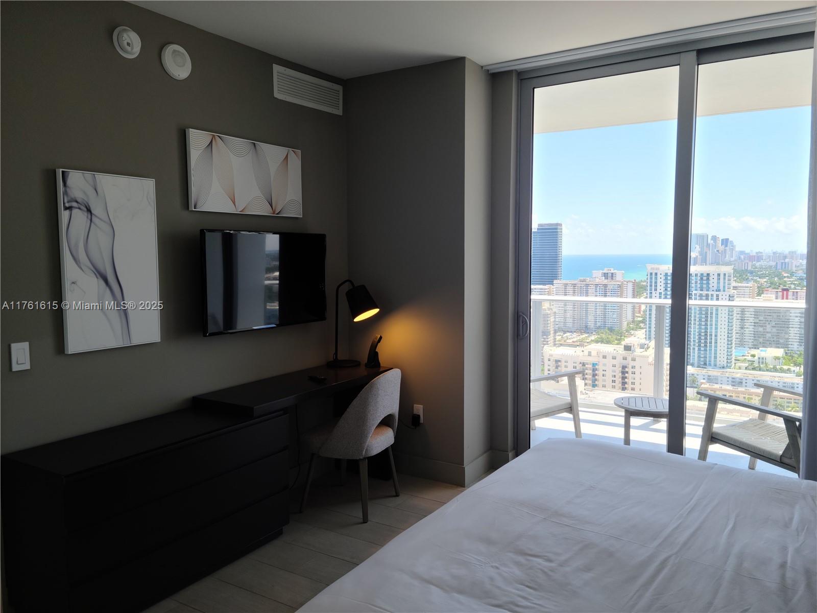 4010 South Ocean Drive, Unit R3309 Hollywood, FL 33019 - Photo 13 of 14 a bedroom with a bed and large window