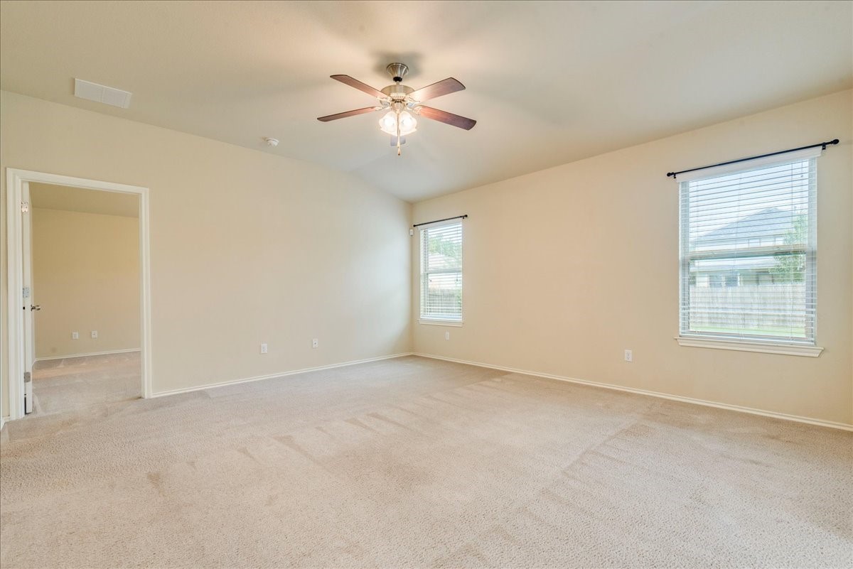 1061 Violet Lane Kyle, TX 78640 - Photo 5 of 34 Living room with carpet flooring and ceiling fan