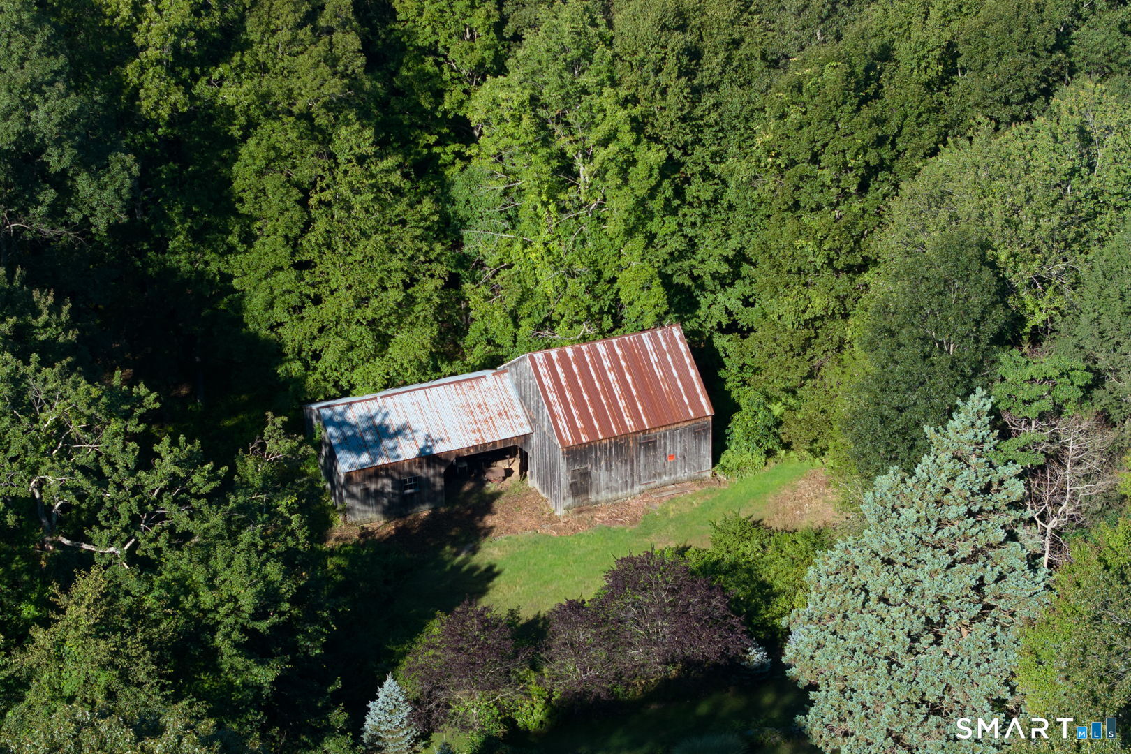 335 Old Post Road Tolland, CT 06084 - Photo 2 of 13 Expansive aerial view showcasing approximately 17 acres of wooded privacy with potential building opportunites.