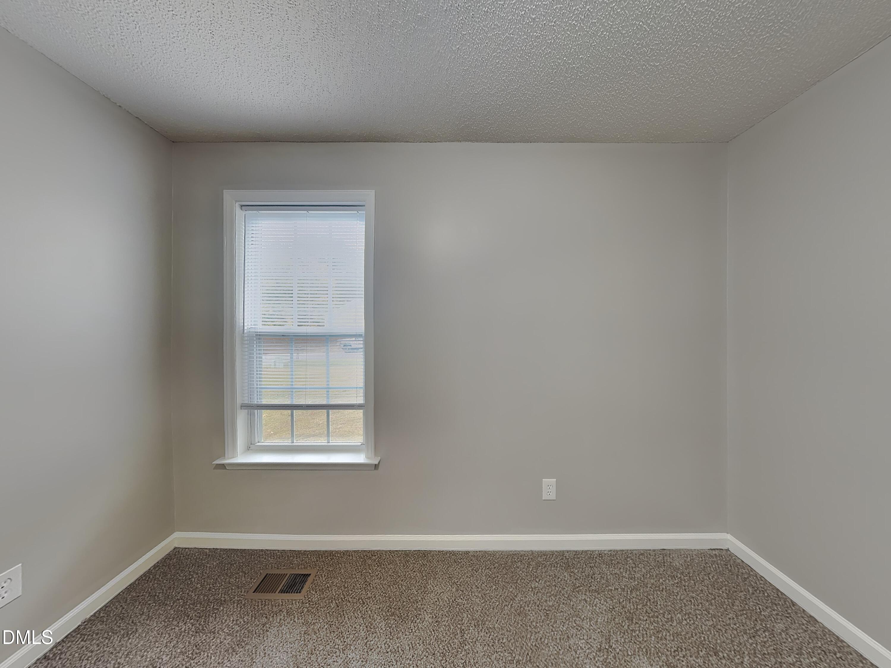 1017 Laurel Leaf Road Zebulon, NC 27597 - Photo 11 of 16 an empty room with a window