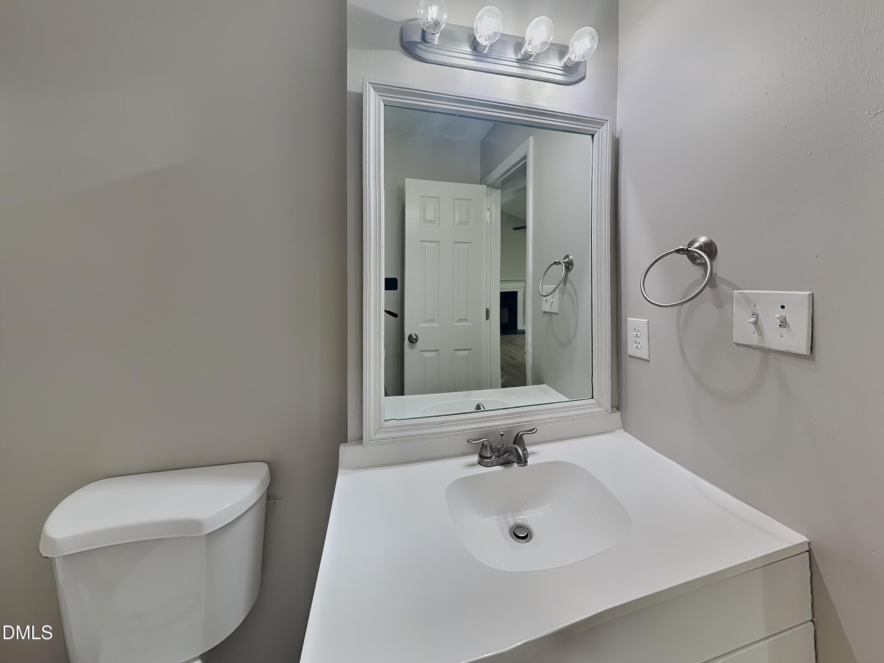 1017 Laurel Leaf Road Zebulon, NC 27597 - Photo 12 of 16 a bathroom with a toilet sink and mirror