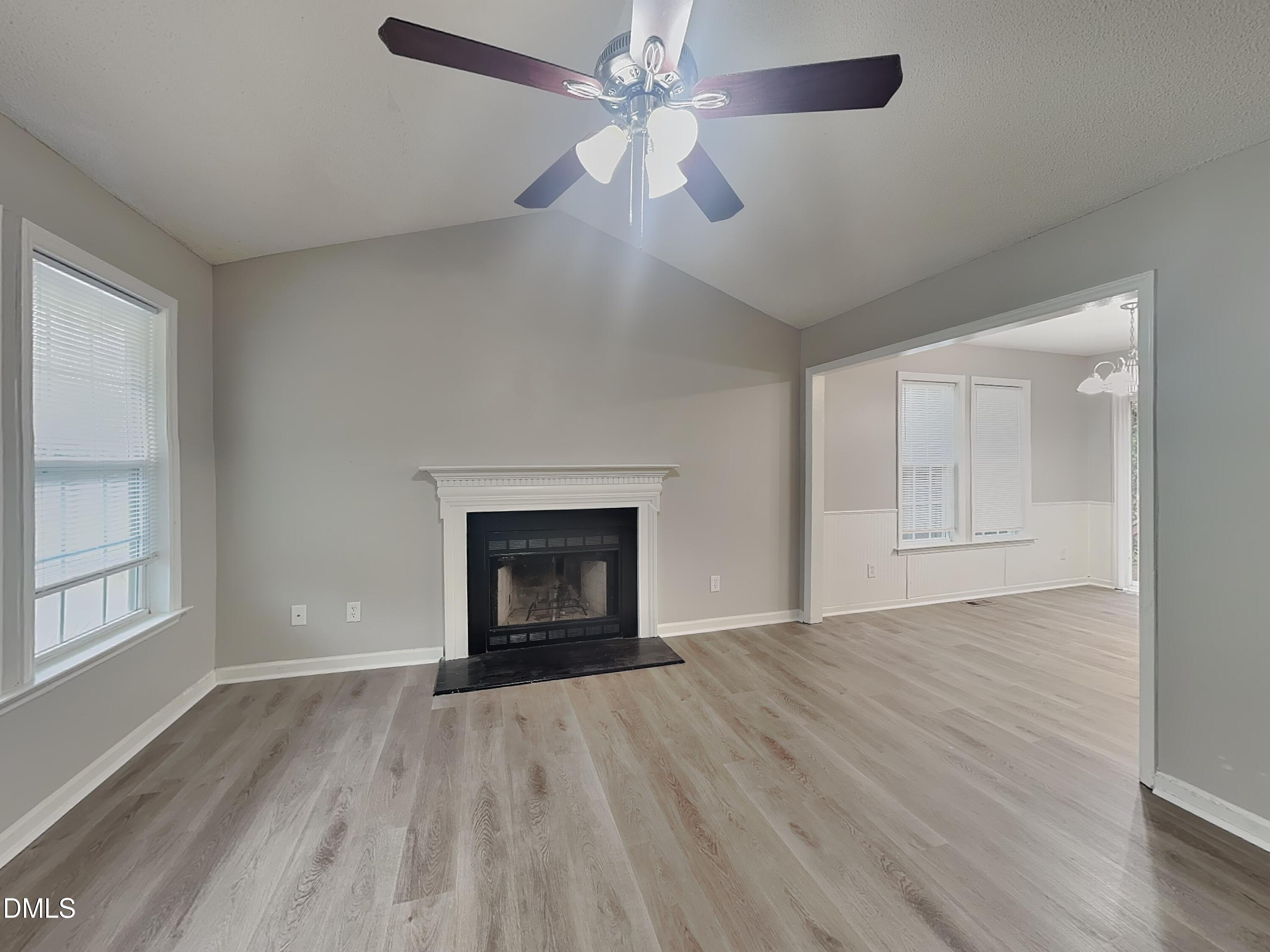 1017 Laurel Leaf Road Zebulon, NC 27597 - Photo 3 of 16 an empty room with windows fireplace and a sink