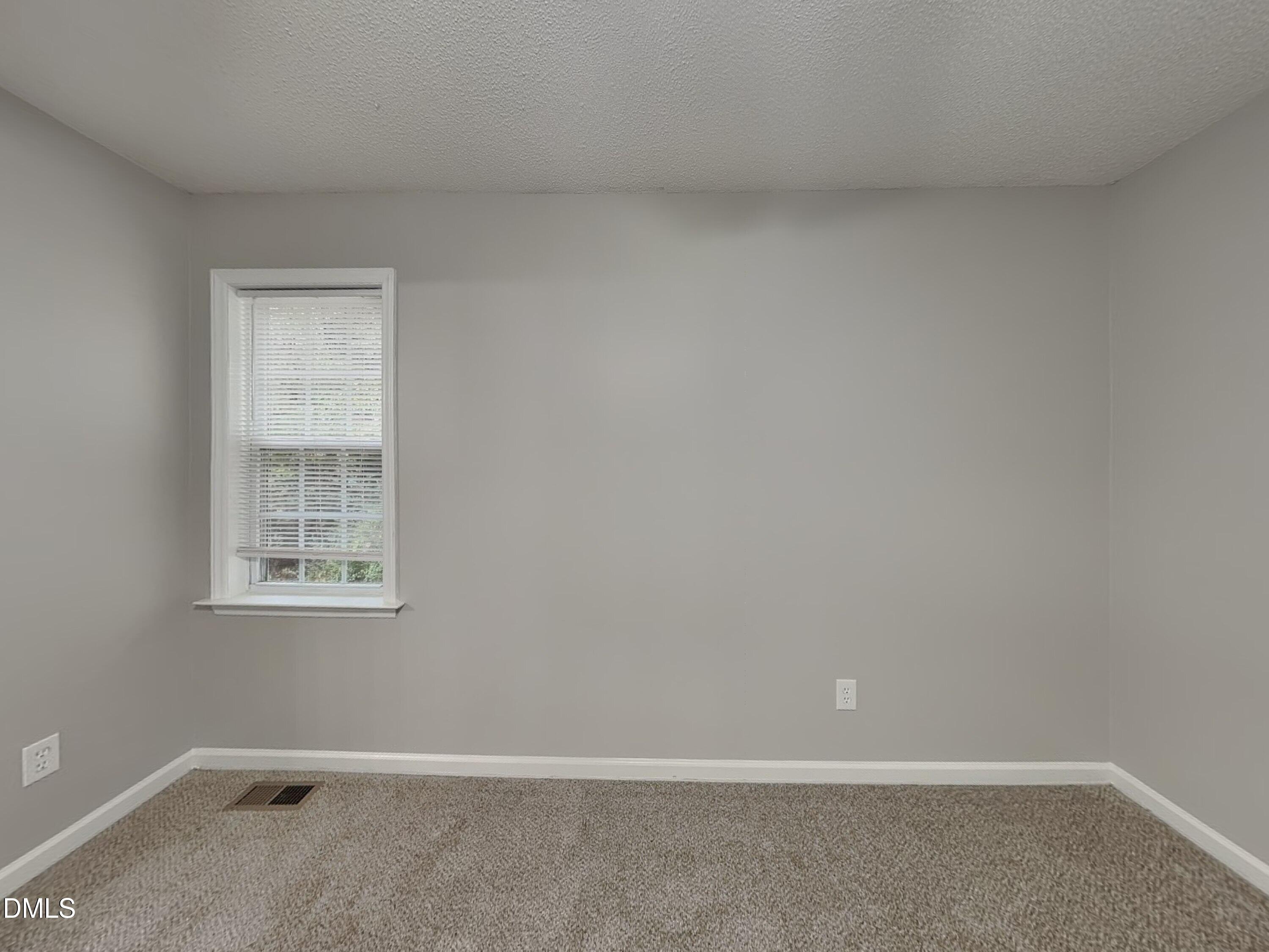 1017 Laurel Leaf Road Zebulon, NC 27597 - Photo 7 of 16 an empty room with a window