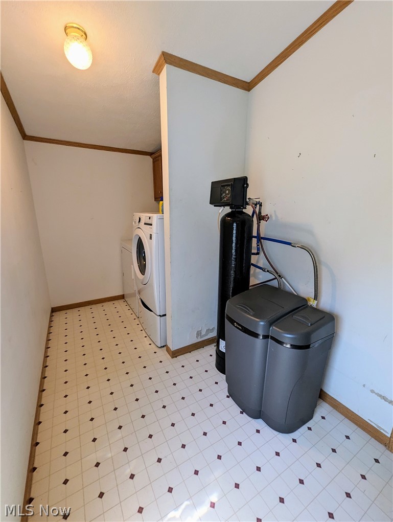9889 Griffith Road Ravenna, OH 44266 - Photo 47 of 49 Washroom featuring washer and dryer, light tile floors, and crown molding