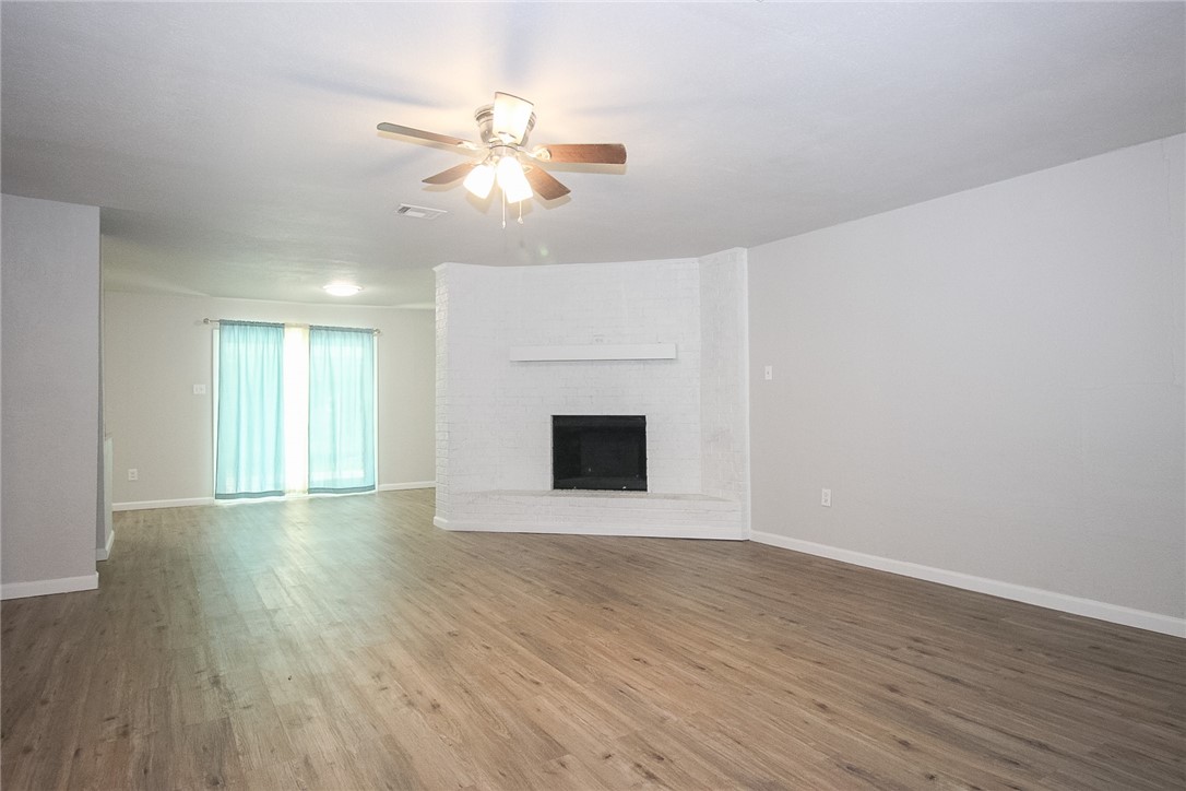 3720 Wingate Drive Waco, TX 76706 - Photo 2 of 18 a view of an empty room with wooden floor and a window