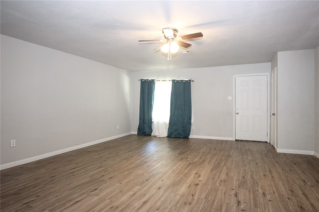 3720 Wingate Drive Waco, TX 76706 - Photo 4 of 18 wooden floor in an empty room with a window