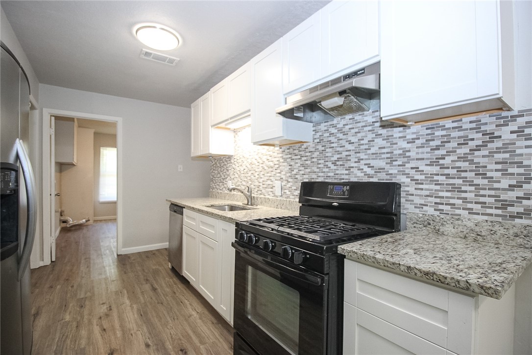 3720 Wingate Drive Waco, TX 76706 - Photo 5 of 18 a kitchen with granite countertop a stove sink and cabinets