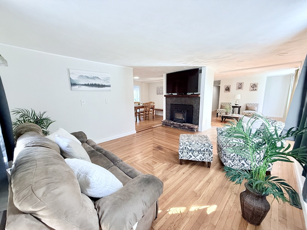 975 South Main Street Bellingham, MA 02019 - Photo 6 of 38 a living room with furniture potted plant and a flat screen tv