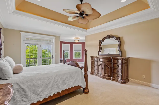 a bed sitting in a spacious bedroom next to a window