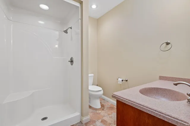 a room with white cabinets and sink