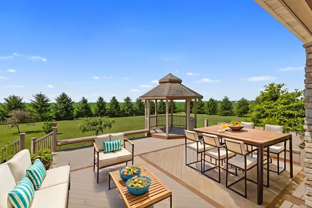 a view of a house with large trees and couches