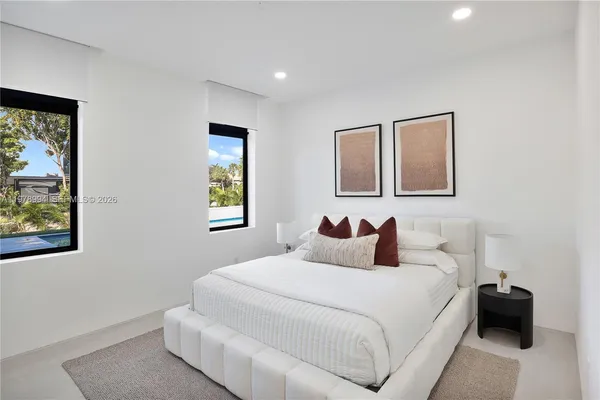a bedroom with a bed and a large mirror