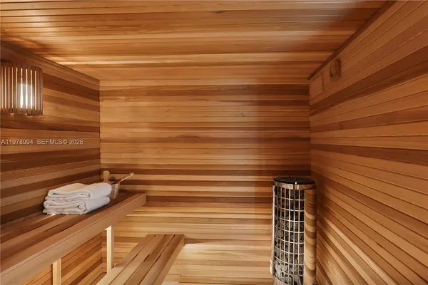 a view of a hallway with wooden floor and entryway