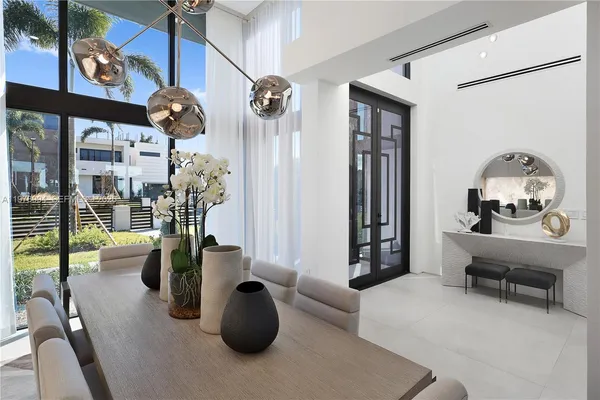a living room with furniture and a floor to ceiling window
