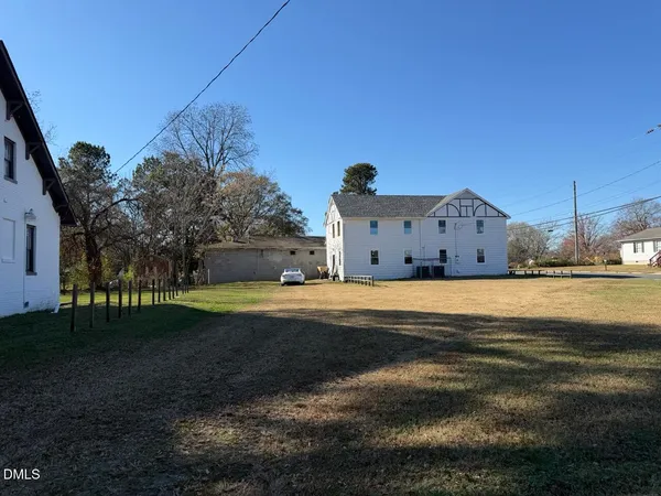 a view of a town with barn house in the background