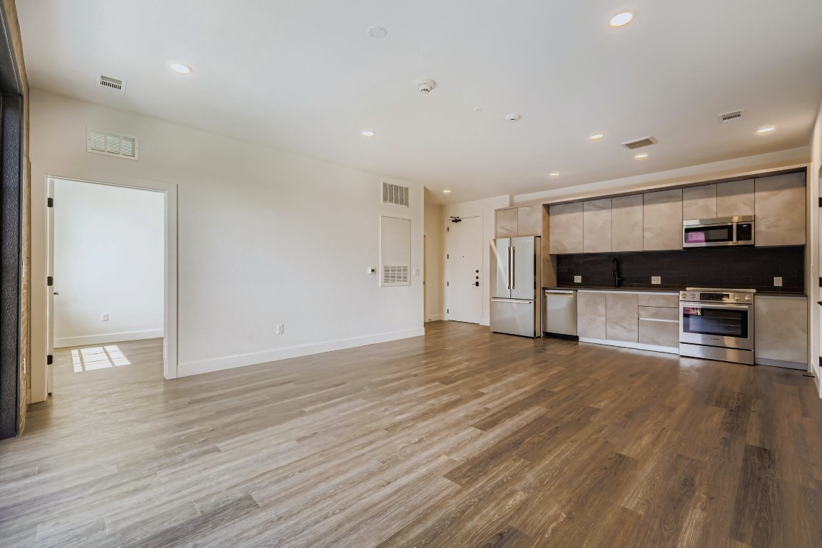 4315 South Congress Avenue, Unit 305 Austin, TX 78745 - Photo 4 of 14 a view of empty room with wooden floor