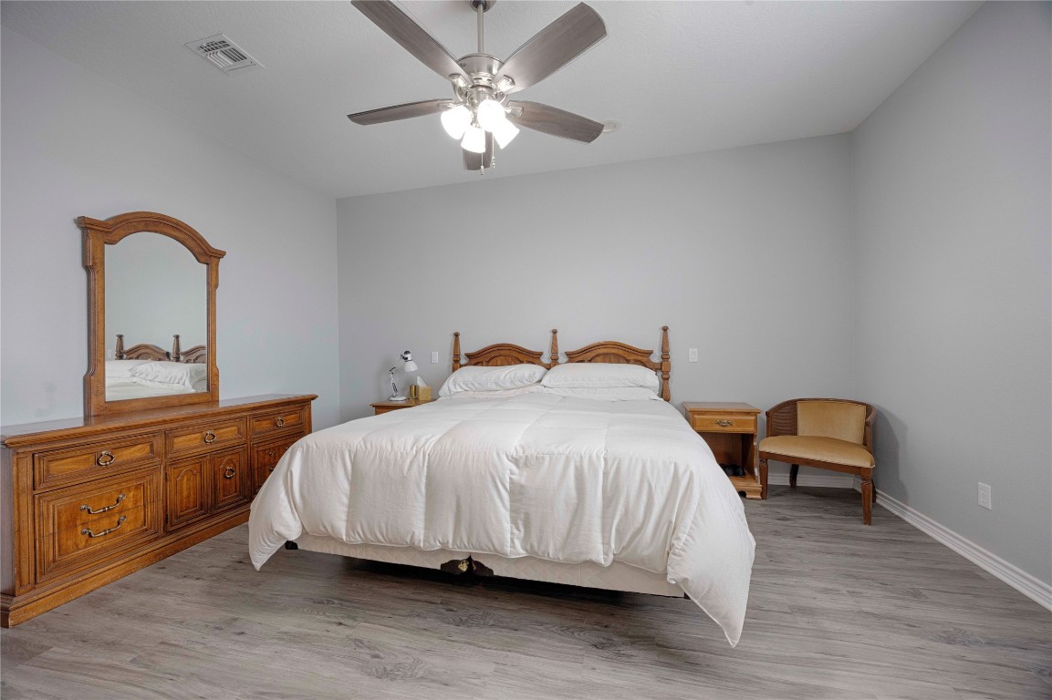 66 County Road 77D Schulenburg, TX 78956 - Photo 26 of 31 a bedroom with a bed and a chandelier