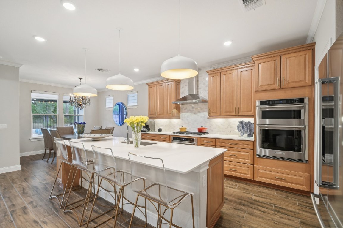 309 Kitty Hawk Road Georgetown, TX 78633 - Photo 13 of 37 a kitchen with stainless steel appliances a table and chairs in it