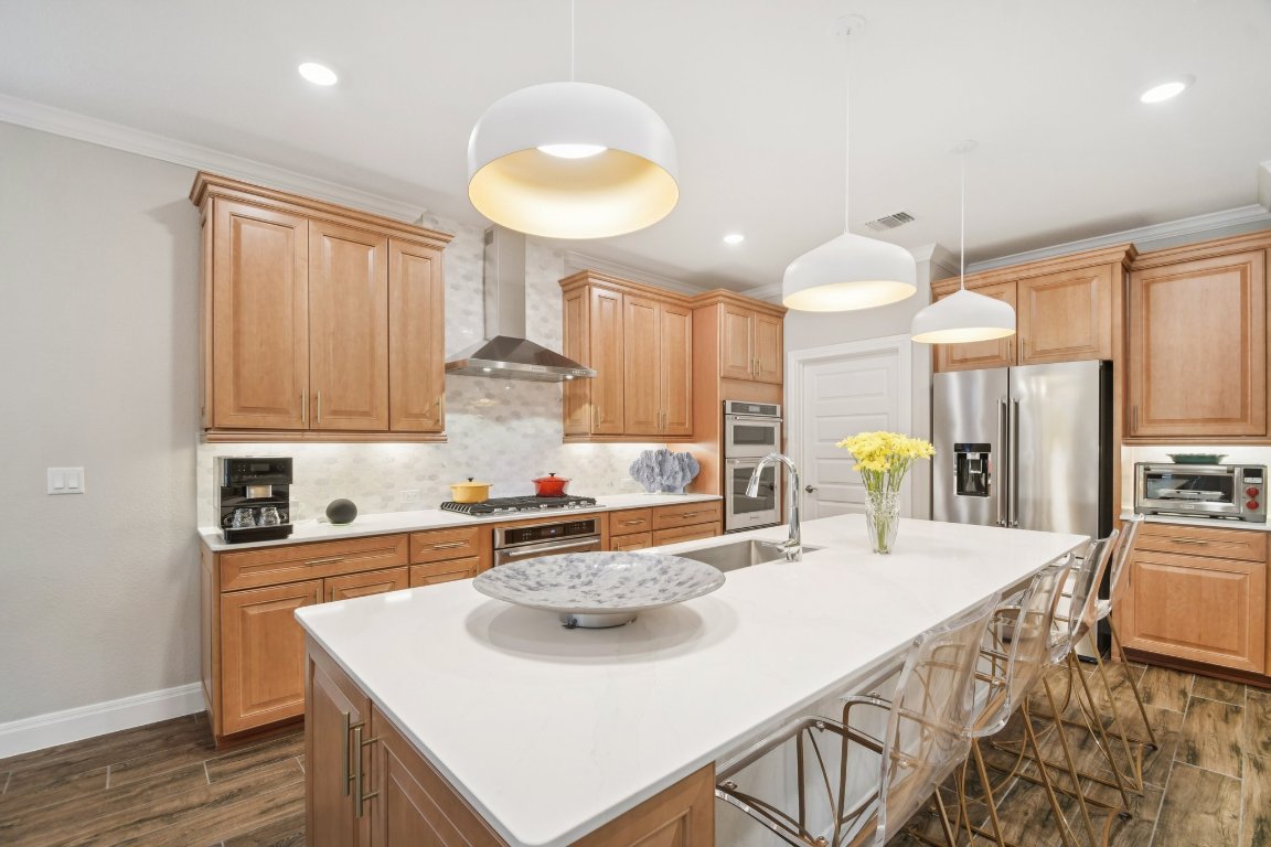 309 Kitty Hawk Road Georgetown, TX 78633 - Photo 14 of 37 a kitchen with kitchen island granite countertop a sink a counter space and stainless steel appliances