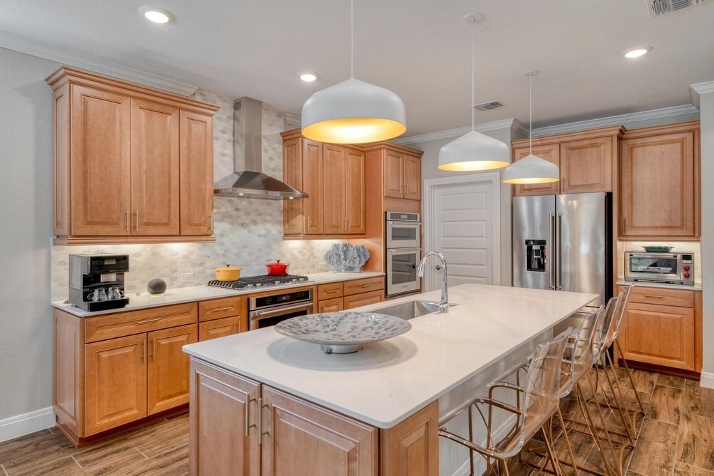 309 Kitty Hawk Road Georgetown, TX 78633 - Photo 16 of 37 a kitchen with stainless steel appliances a sink a stove a refrigerator and cabinets