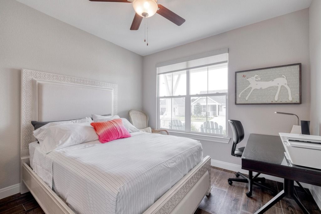 309 Kitty Hawk Road Georgetown, TX 78633 - Photo 26 of 37 a bedroom with a bed a computer on a desk and chair