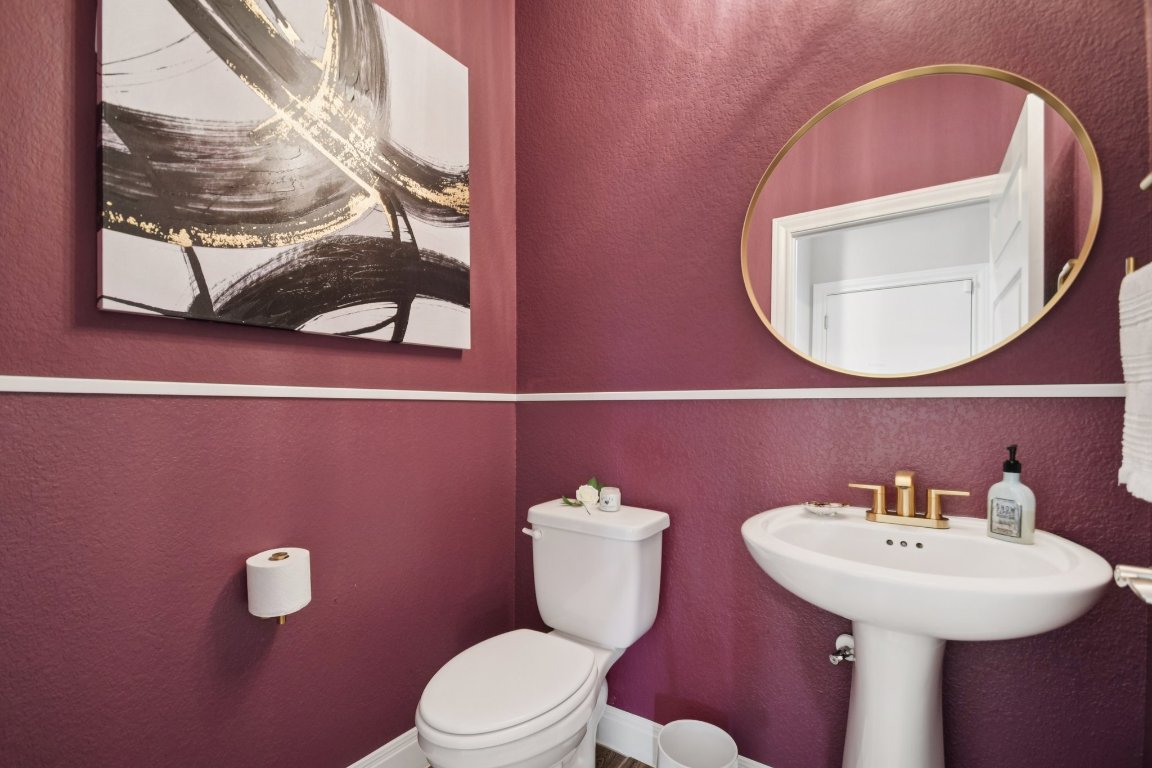 309 Kitty Hawk Road Georgetown, TX 78633 - Photo 30 of 37 a bathroom with a toilet a sink and mirror