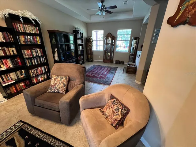 a living room with furniture and a book shelf