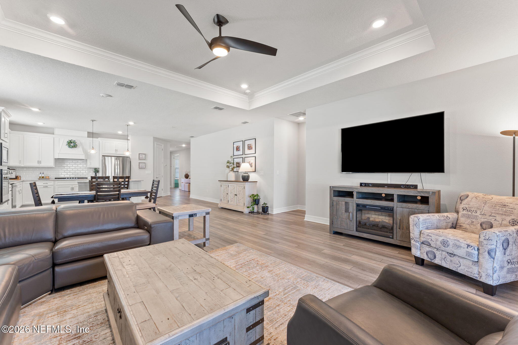 345 Muhly Grass Street Yulee, FL 32097 - Photo 14 of 42 a living room with furniture and a flat screen tv