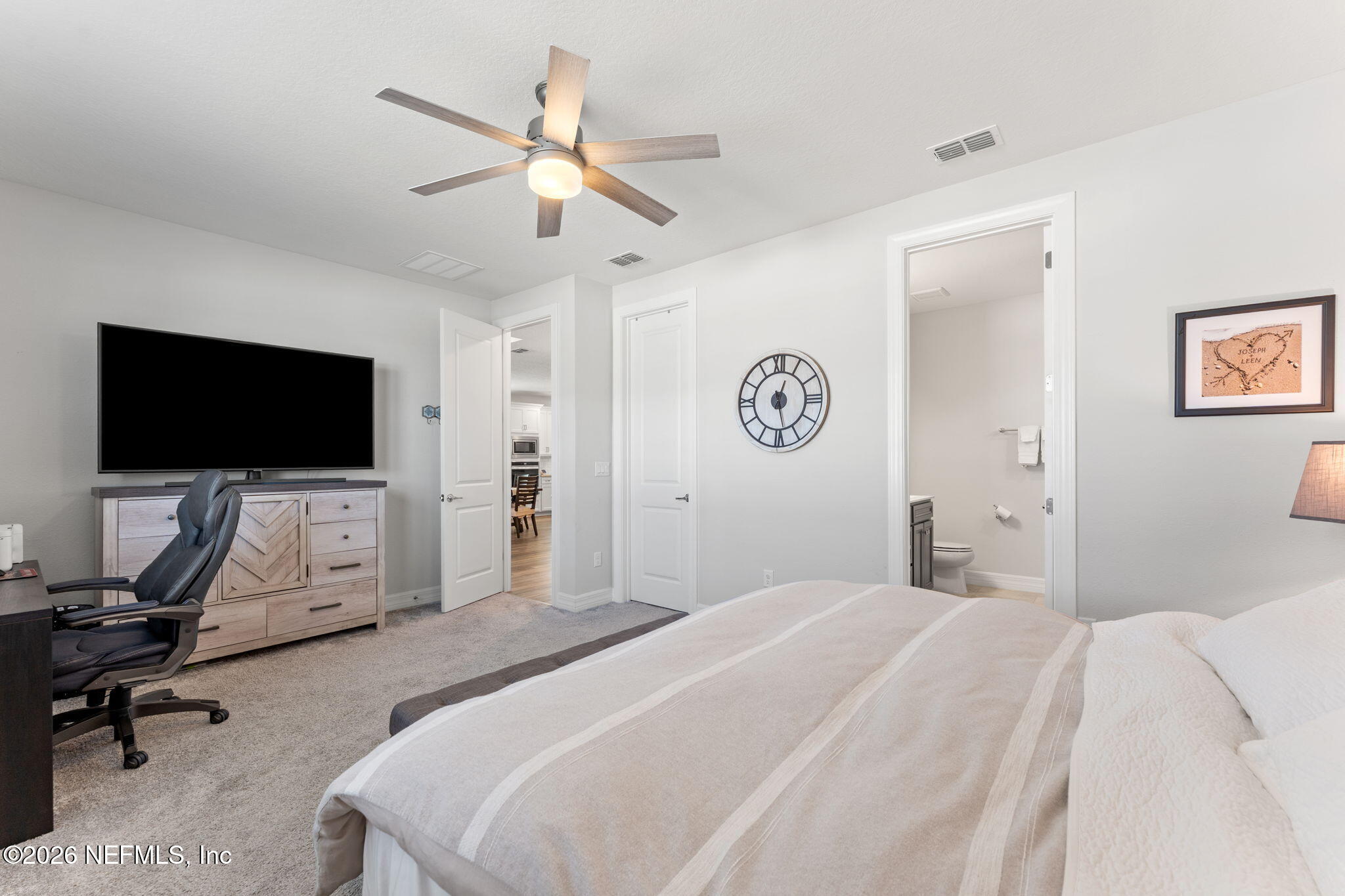 345 Muhly Grass Street Yulee, FL 32097 - Photo 16 of 42 a bedroom with a bed and a flat screen tv