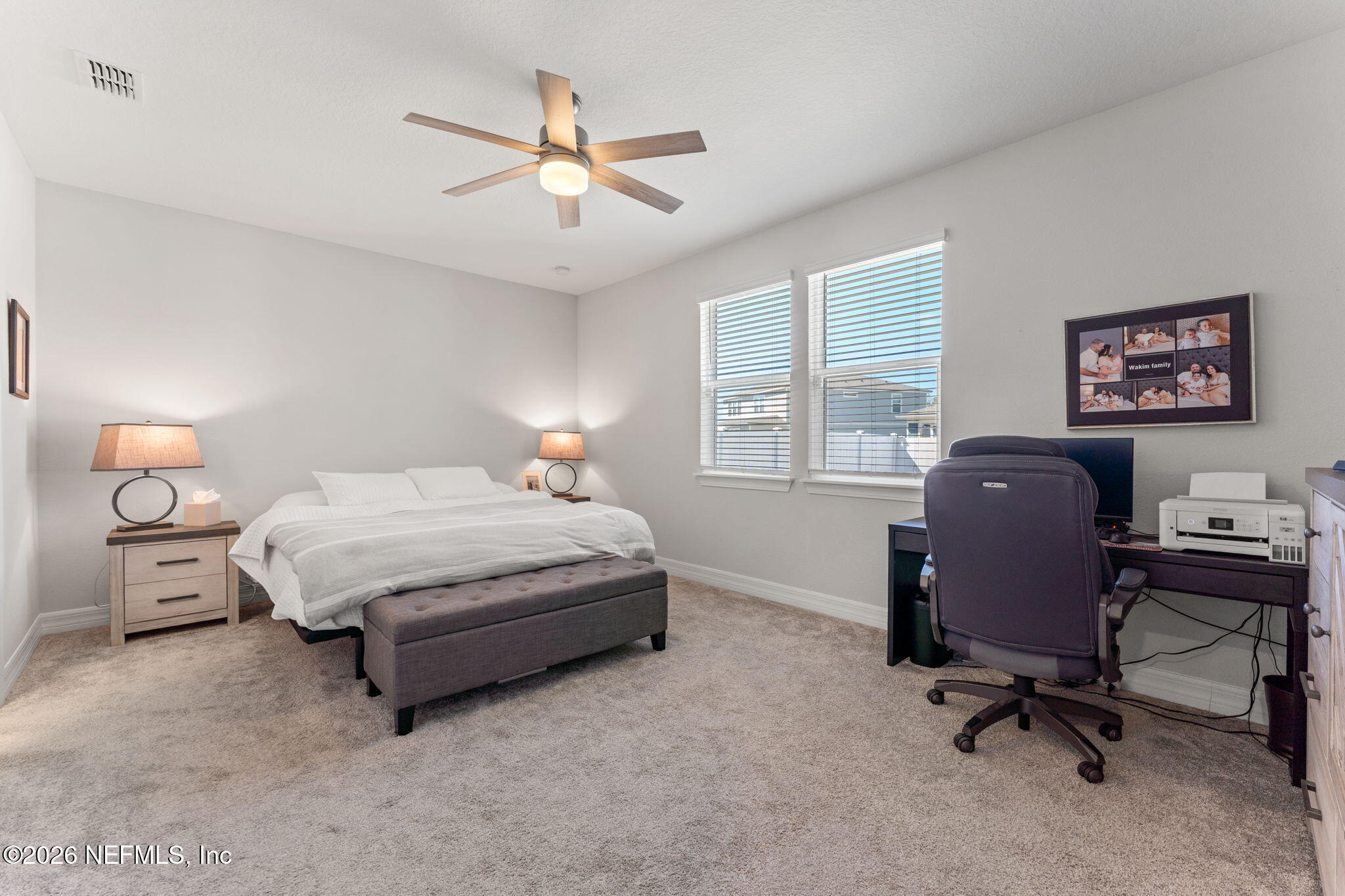 345 Muhly Grass Street Yulee, FL 32097 - Photo 17 of 42 a bedroom with a bed and a chandelier