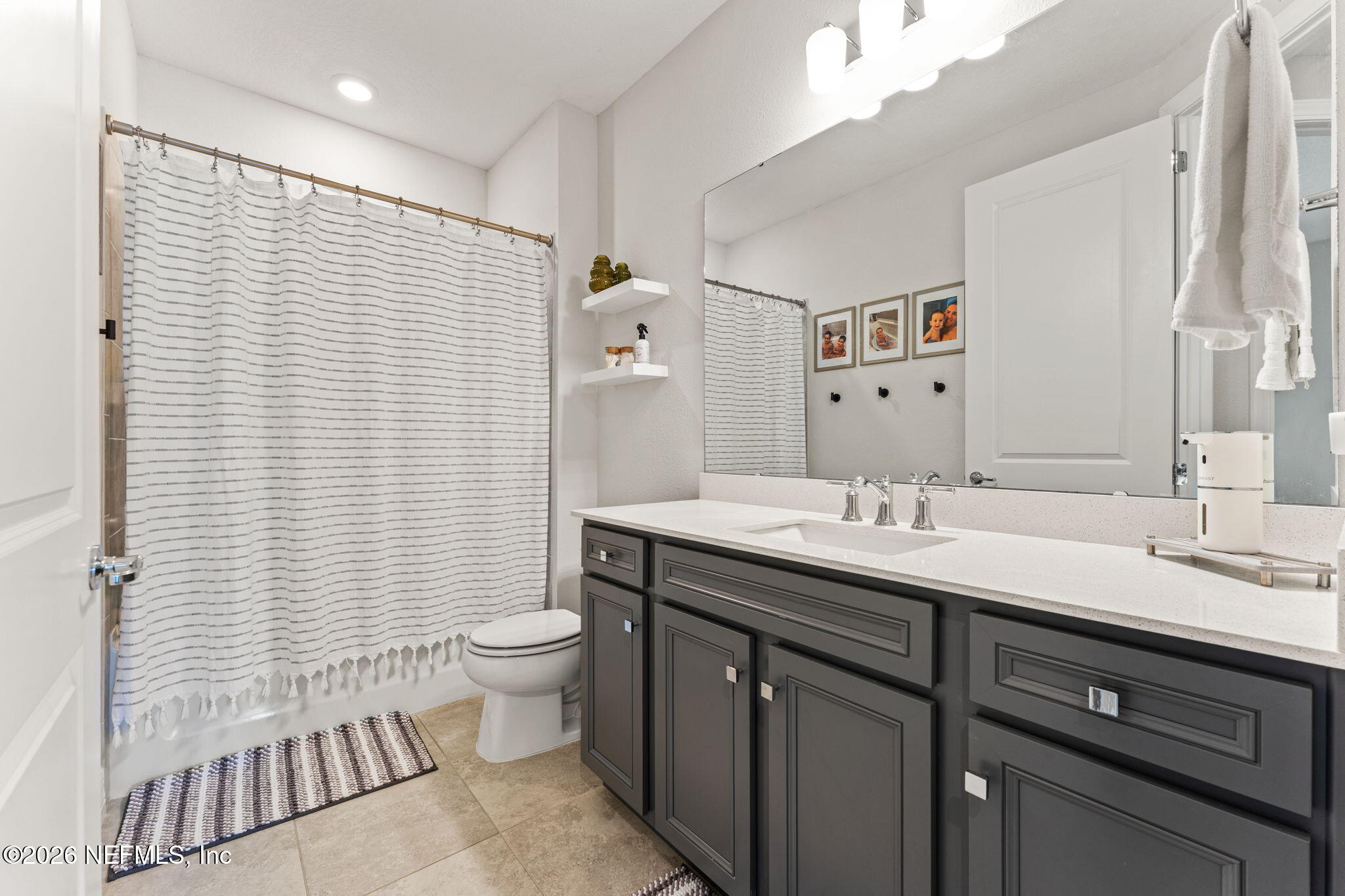 345 Muhly Grass Street Yulee, FL 32097 - Photo 22 of 42 a bathroom with a double vanity sink toilet and a mirror