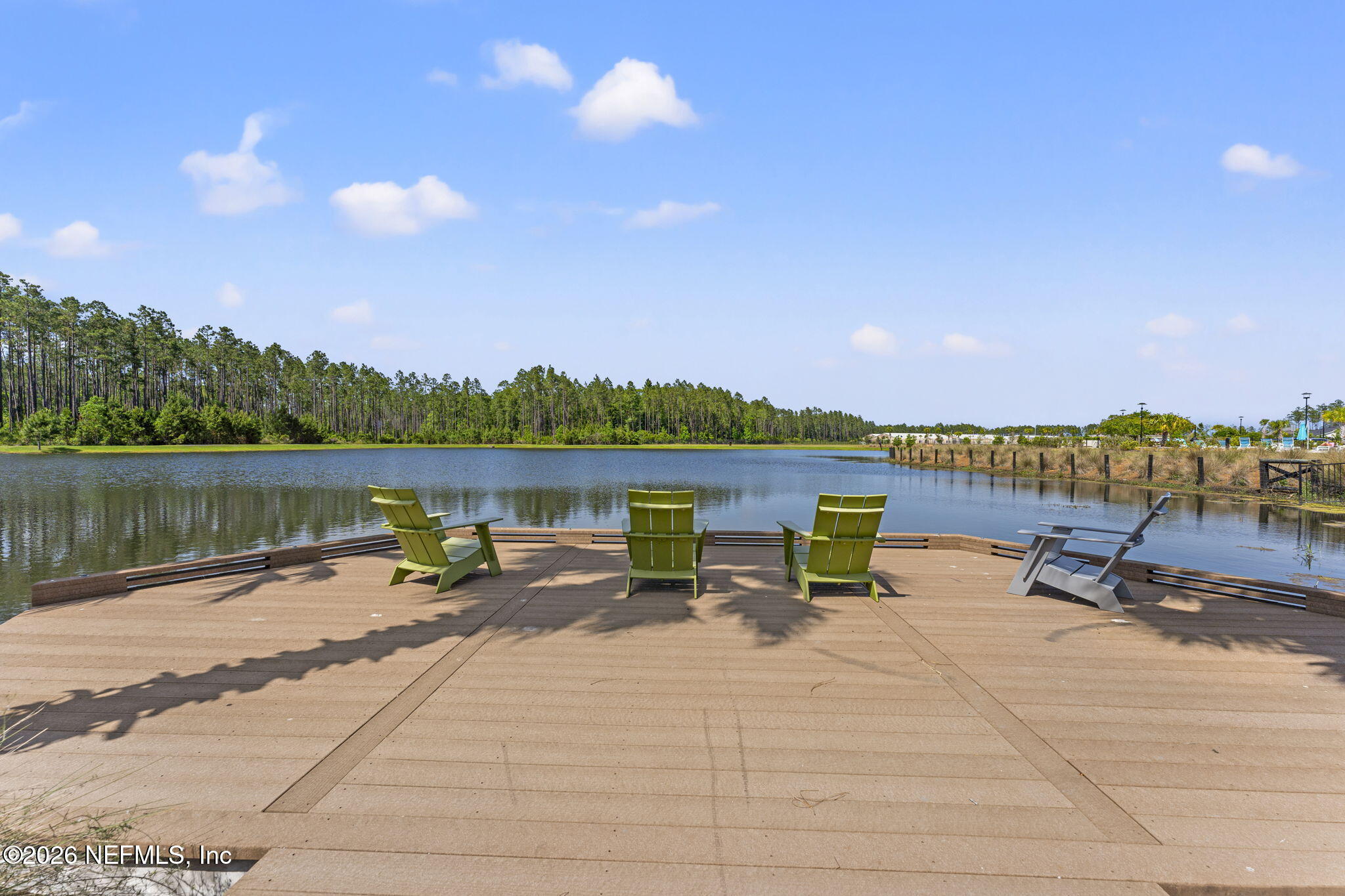 345 Muhly Grass Street Yulee, FL 32097 - Photo 35 of 42 a view of a lake with tables and chairs