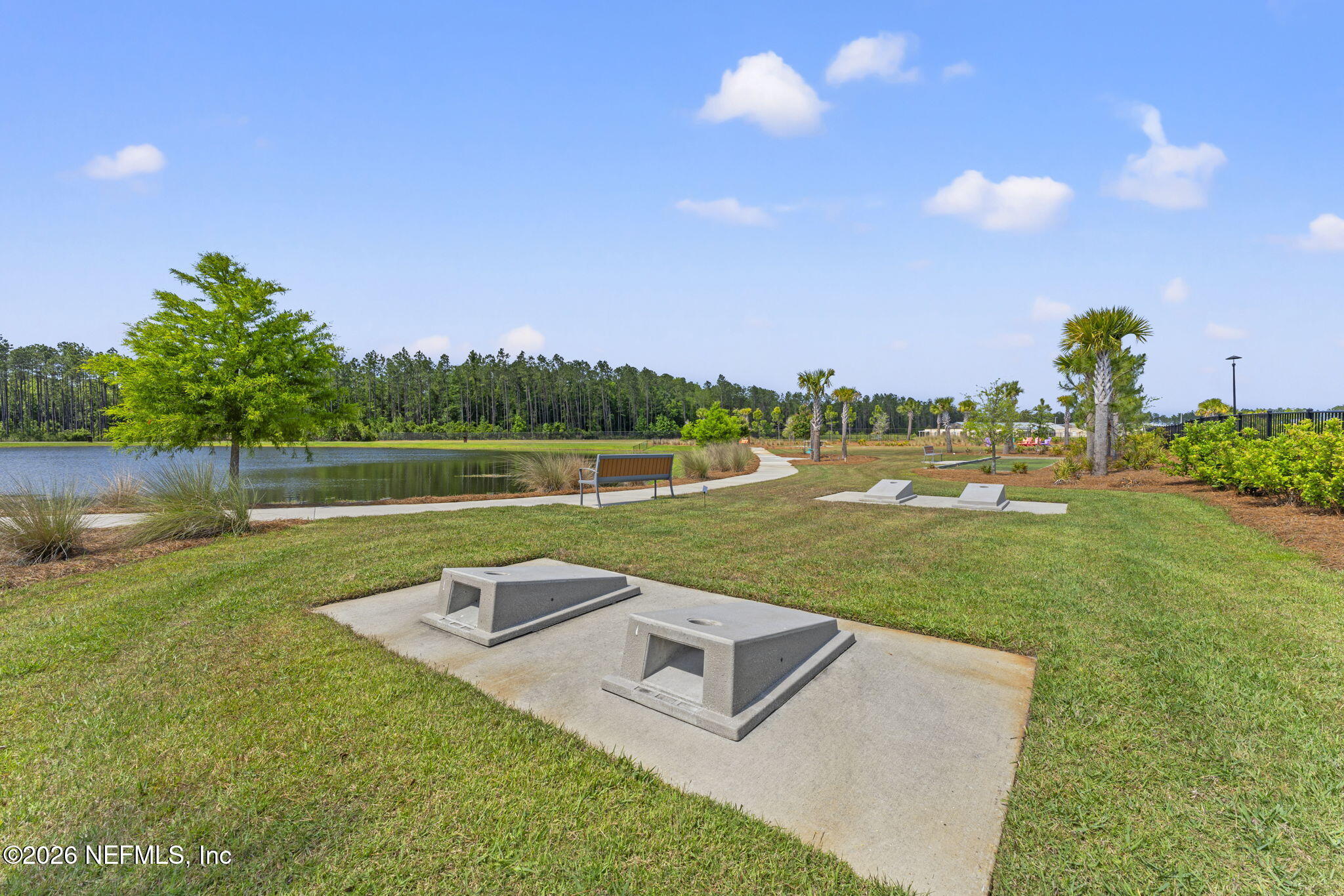 345 Muhly Grass Street Yulee, FL 32097 - Photo 39 of 42 a view of a lake with houses in the background