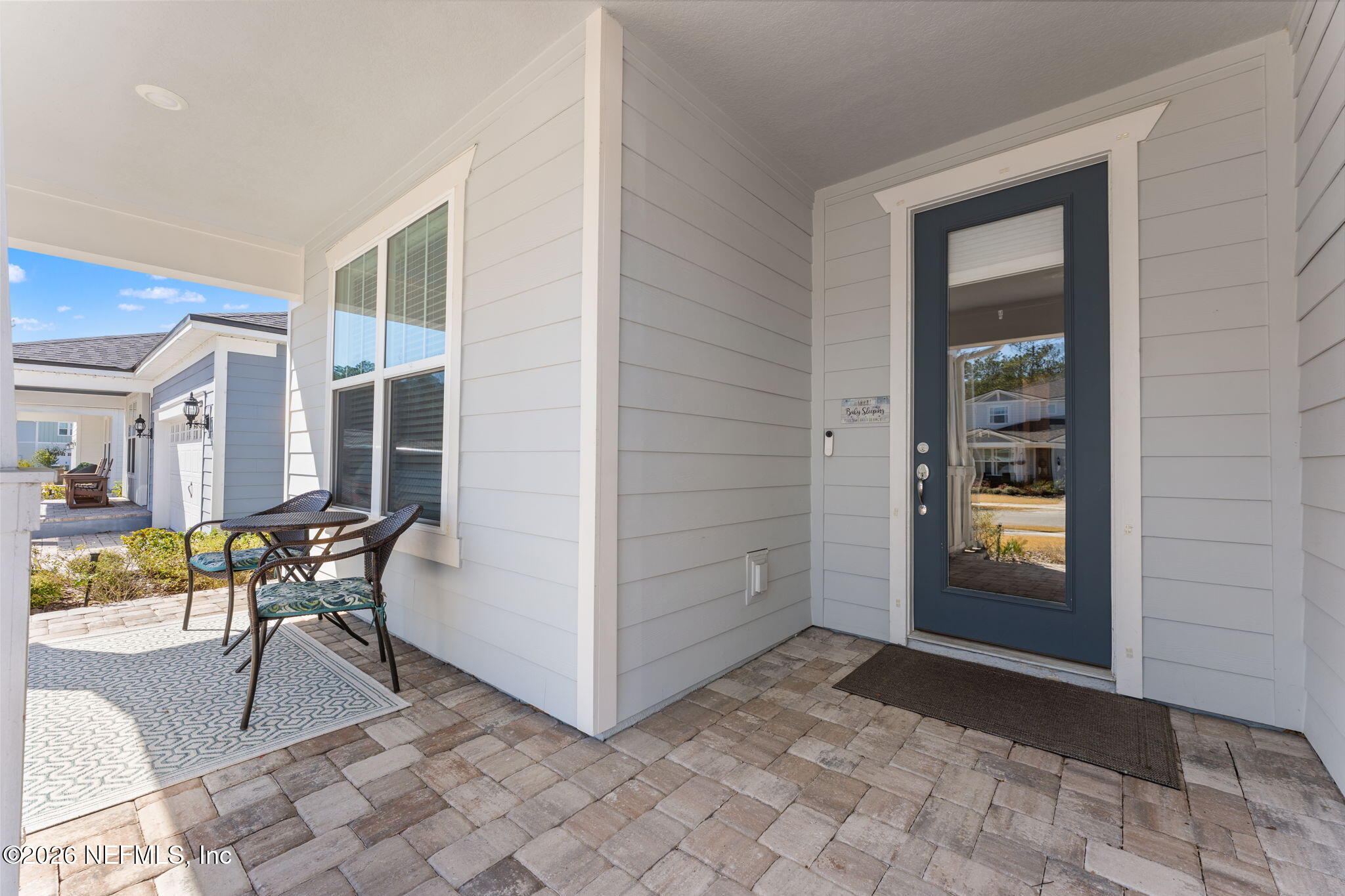 345 Muhly Grass Street Yulee, FL 32097 - Photo 4 of 42 a view of a hallway with dining area and glass door