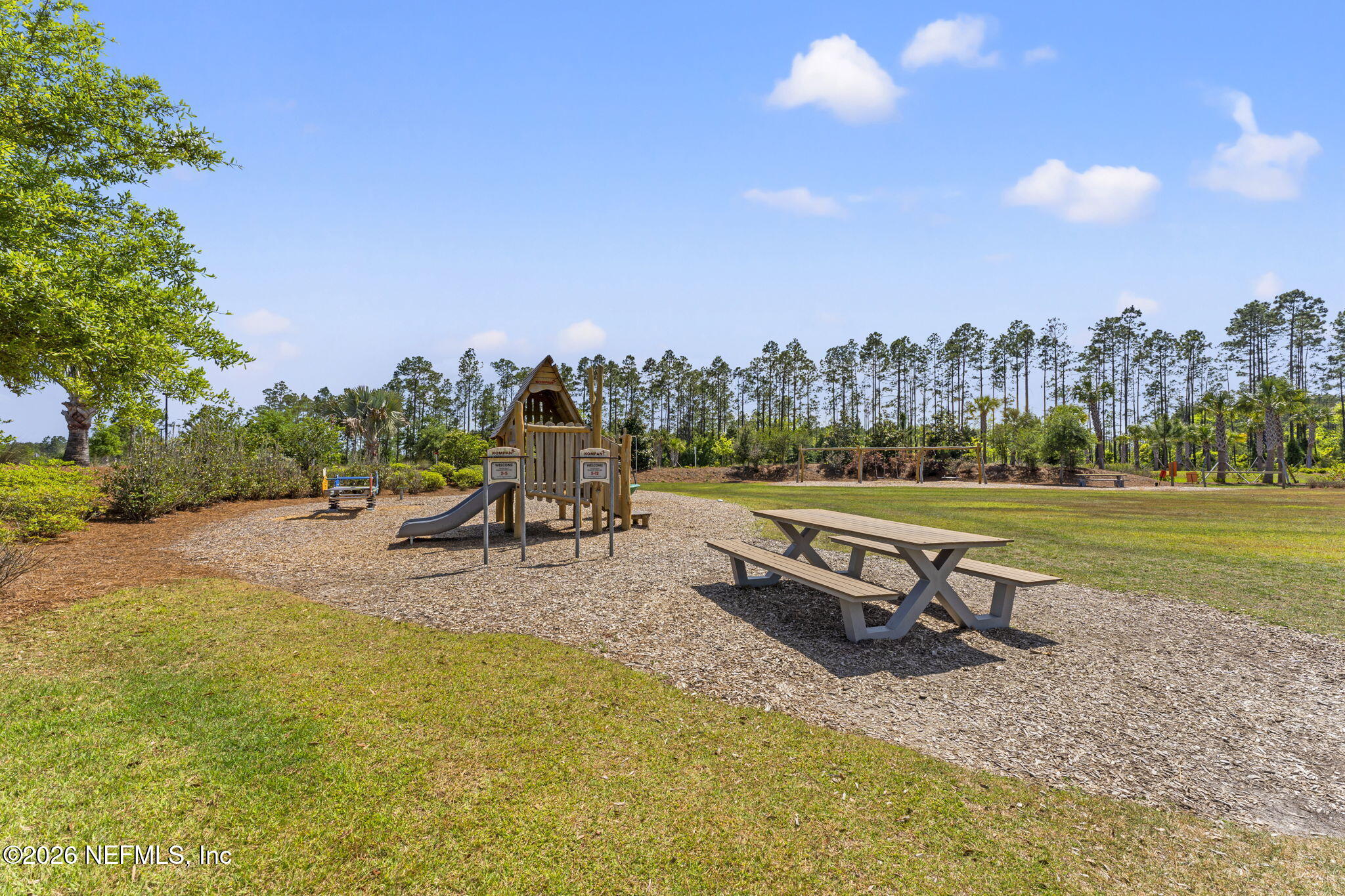 345 Muhly Grass Street Yulee, FL 32097 - Photo 42 of 42 swimming pool with outdoor seating and trees