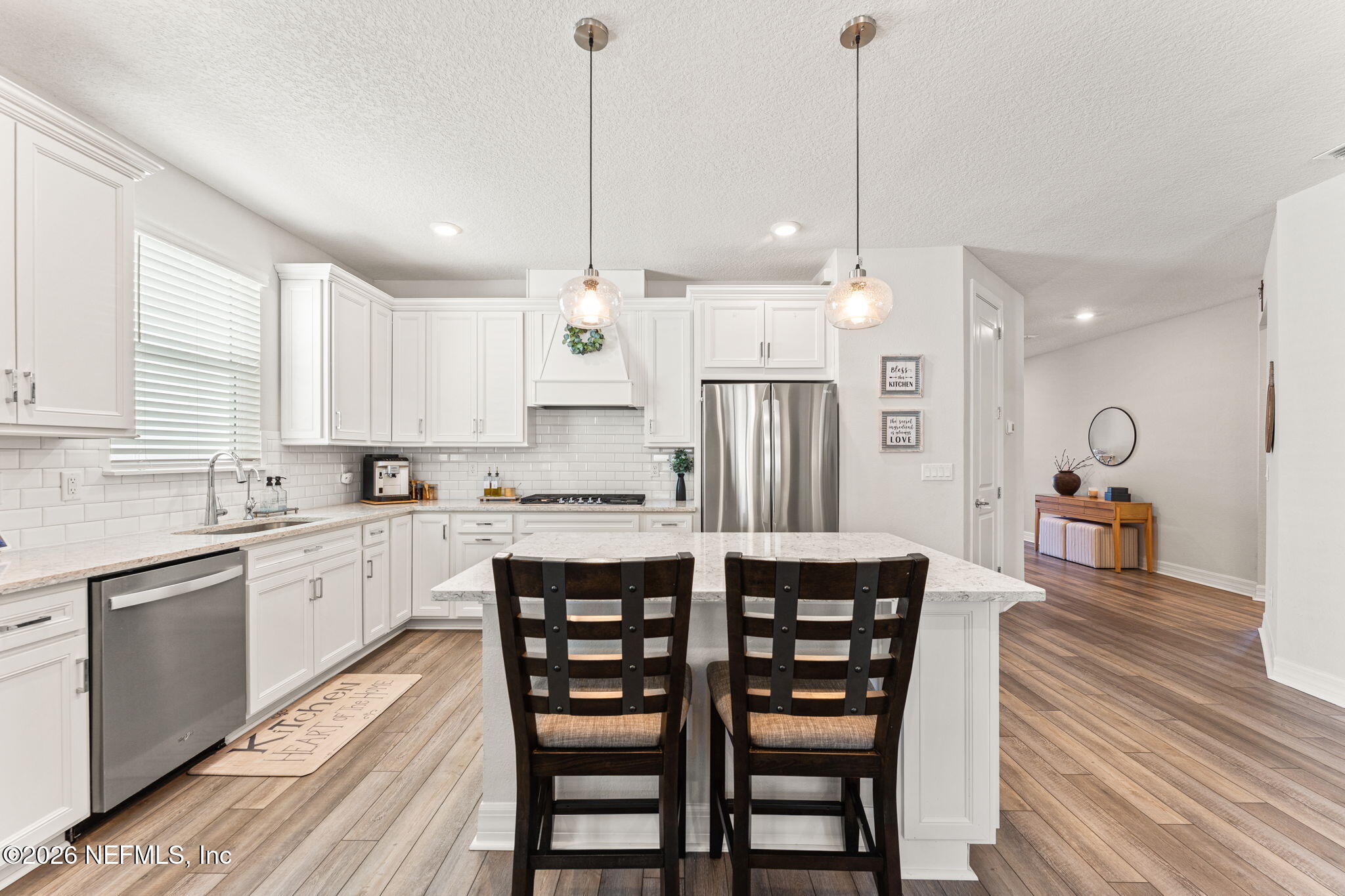 345 Muhly Grass Street Yulee, FL 32097 - Photo 9 of 42 a large kitchen with a table and chairs