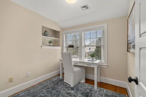 a view of a room that has a window and furniture