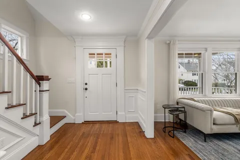 a view of a livingroom with furniture hardwood floor and staircase