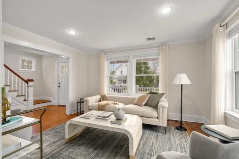 a bedroom with furniture and a large window