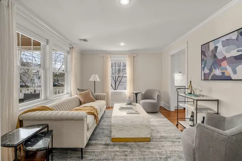 a living room with furniture and windows