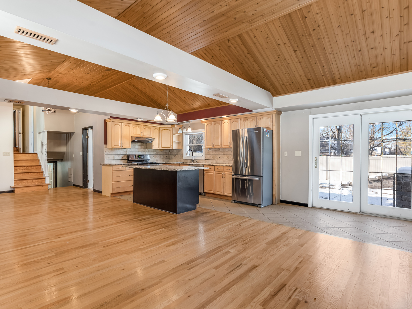 25216 River Road Lake Barrington, IL 60010 - Photo 2 of 36 a large white kitchen with wooden floors and stainless steel appliances
