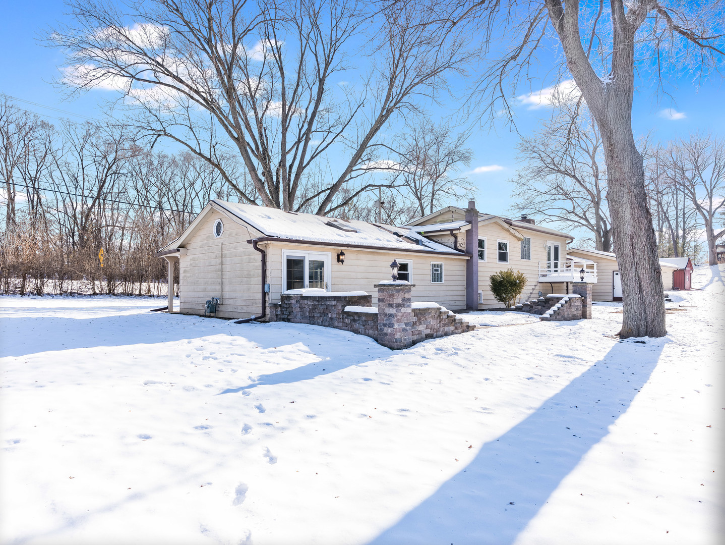 25216 River Road Lake Barrington, IL 60010 - Photo 25 of 36 a view of a white house with a yard covered in snow
