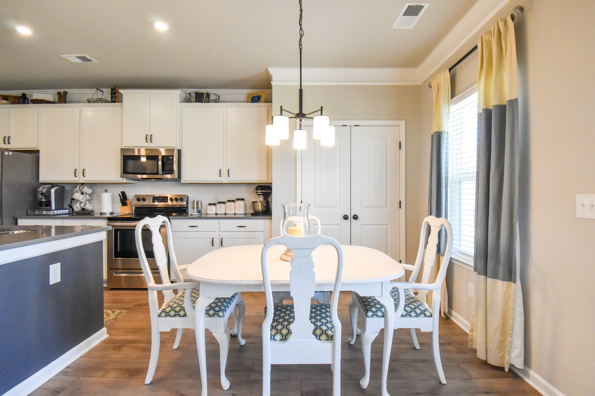 2991 Timewinder Way Columbia, TN 38401 - Photo 10 of 29 a kitchen with stainless steel appliances kitchen island granite countertop a dining table chairs and a refrigerator