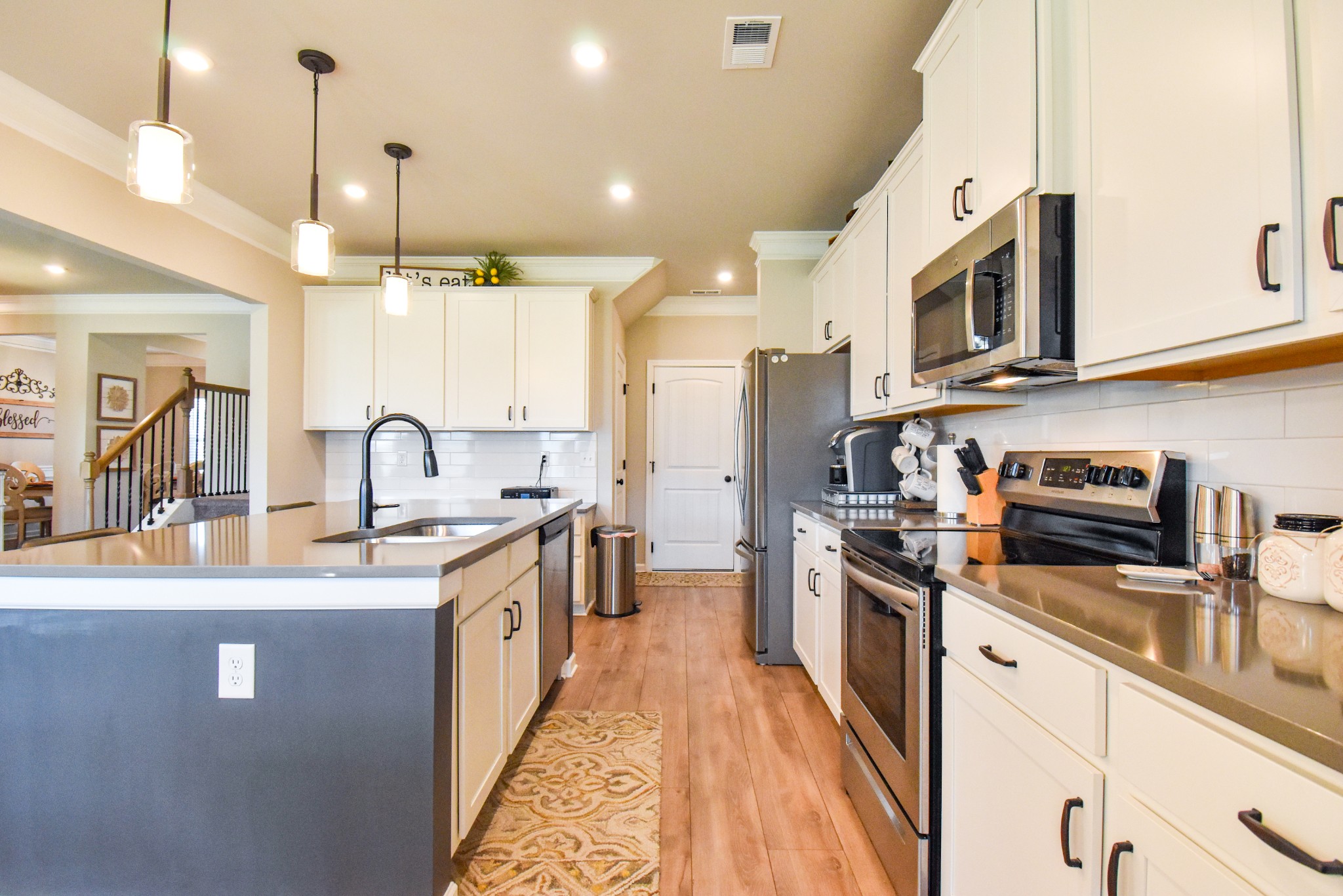 2991 Timewinder Way Columbia, TN 38401 - Photo 27 of 29 a kitchen with stainless steel appliances granite countertop a sink and a stove