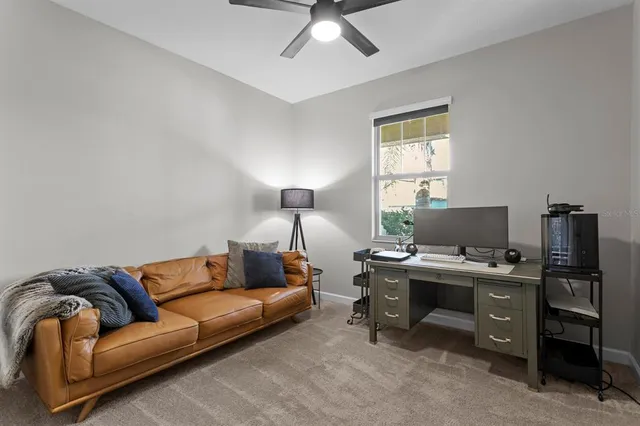 a view of a livingroom with workspace and a window