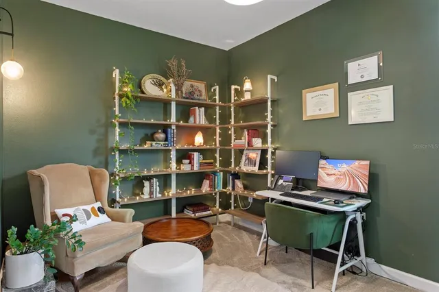 a work room with furniture and book shelf